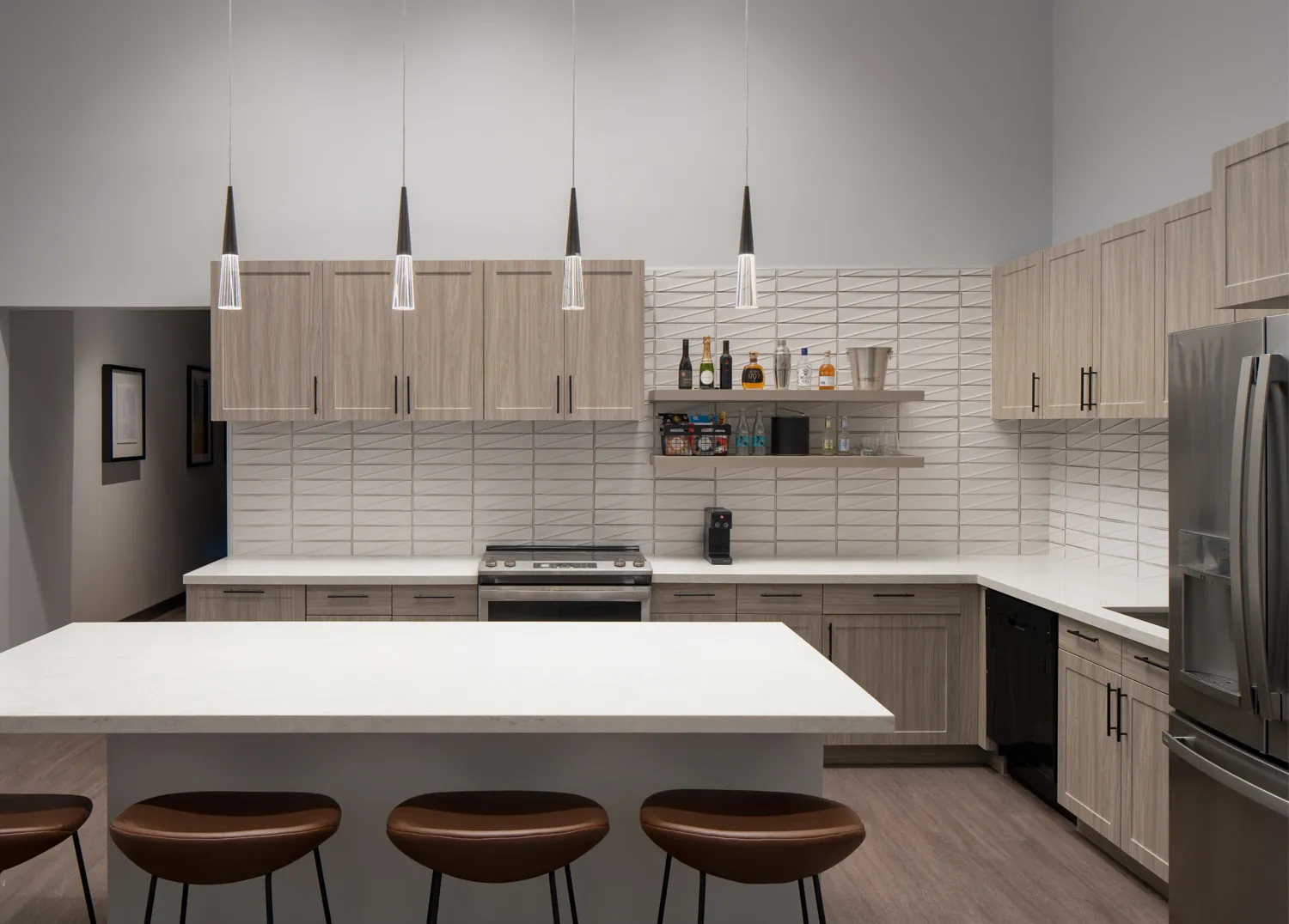 A kitchen with a white island and brown stools