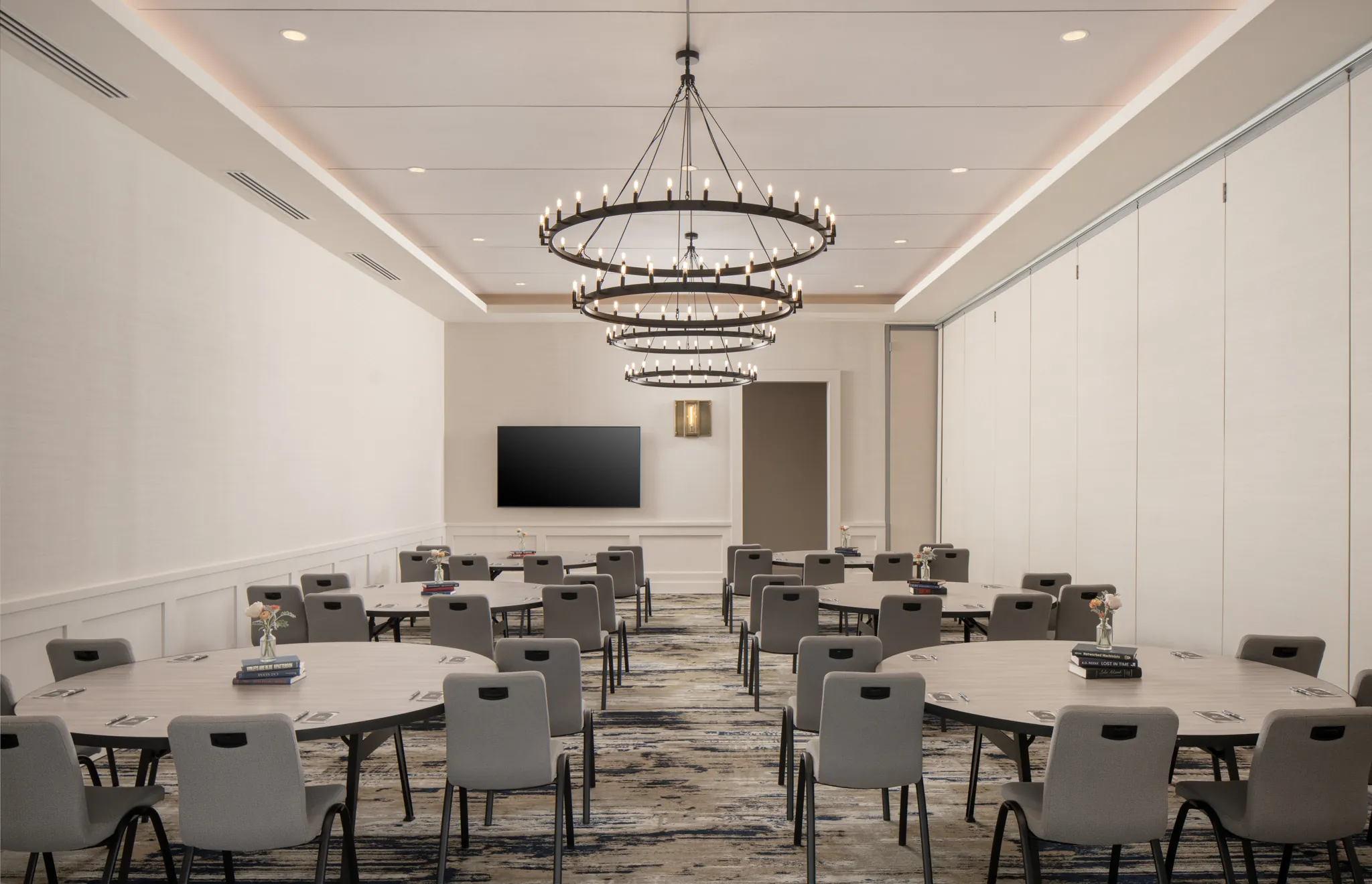 A meeting room with round tables and chairs