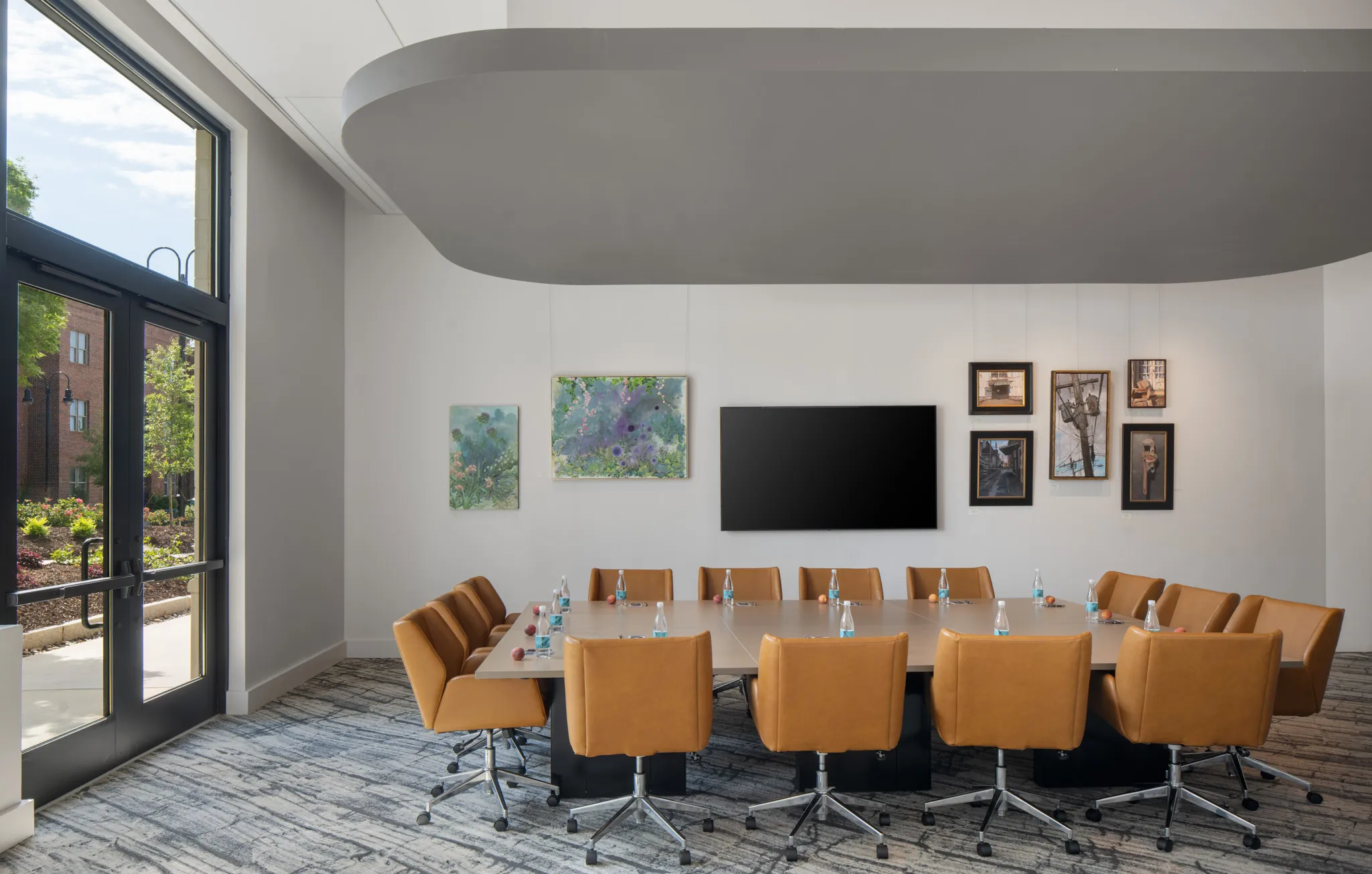 A meeting room with a table and chairs