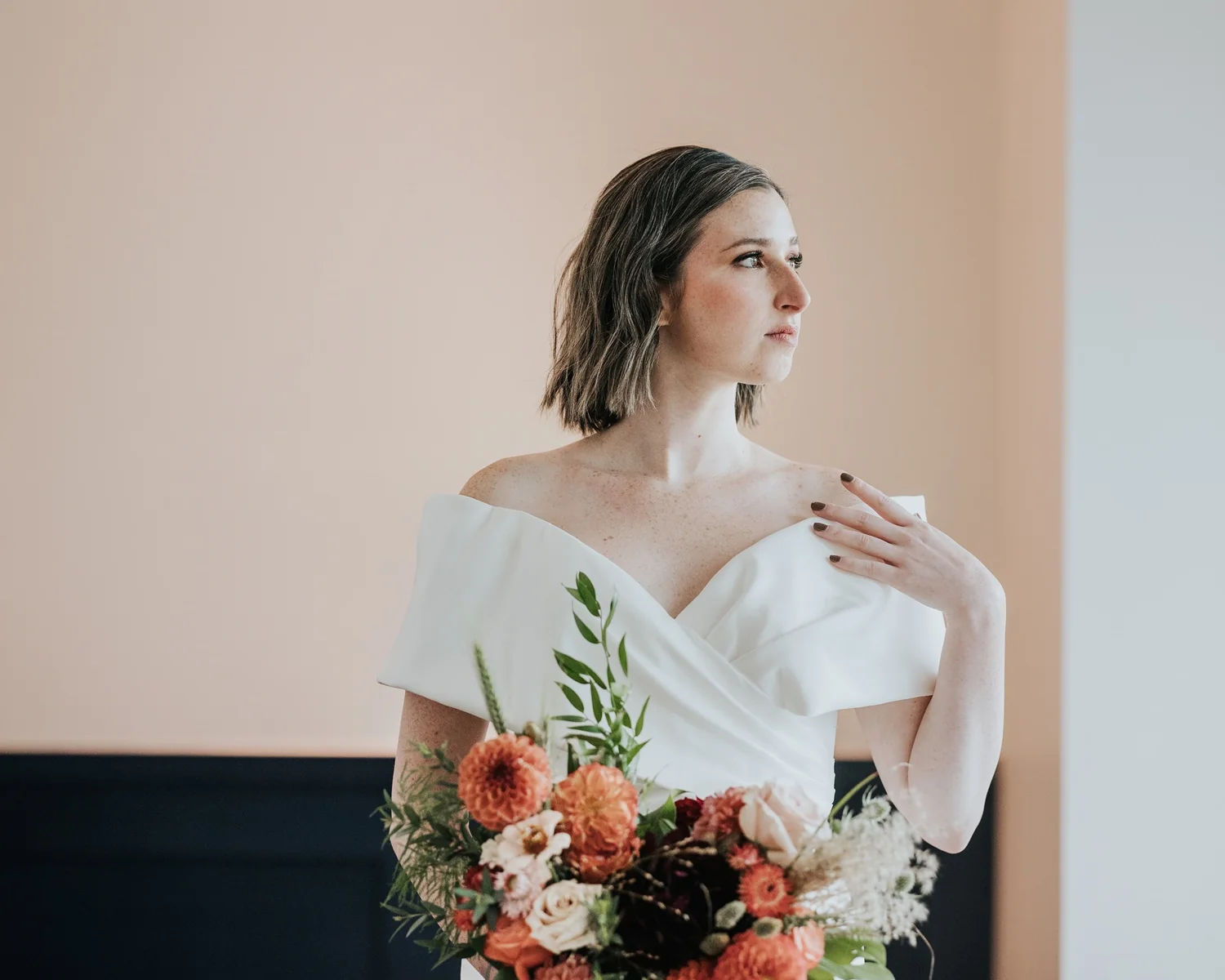 A person in a white dress holding a bouquet of flowers in a Town at Trilith wedding reception space